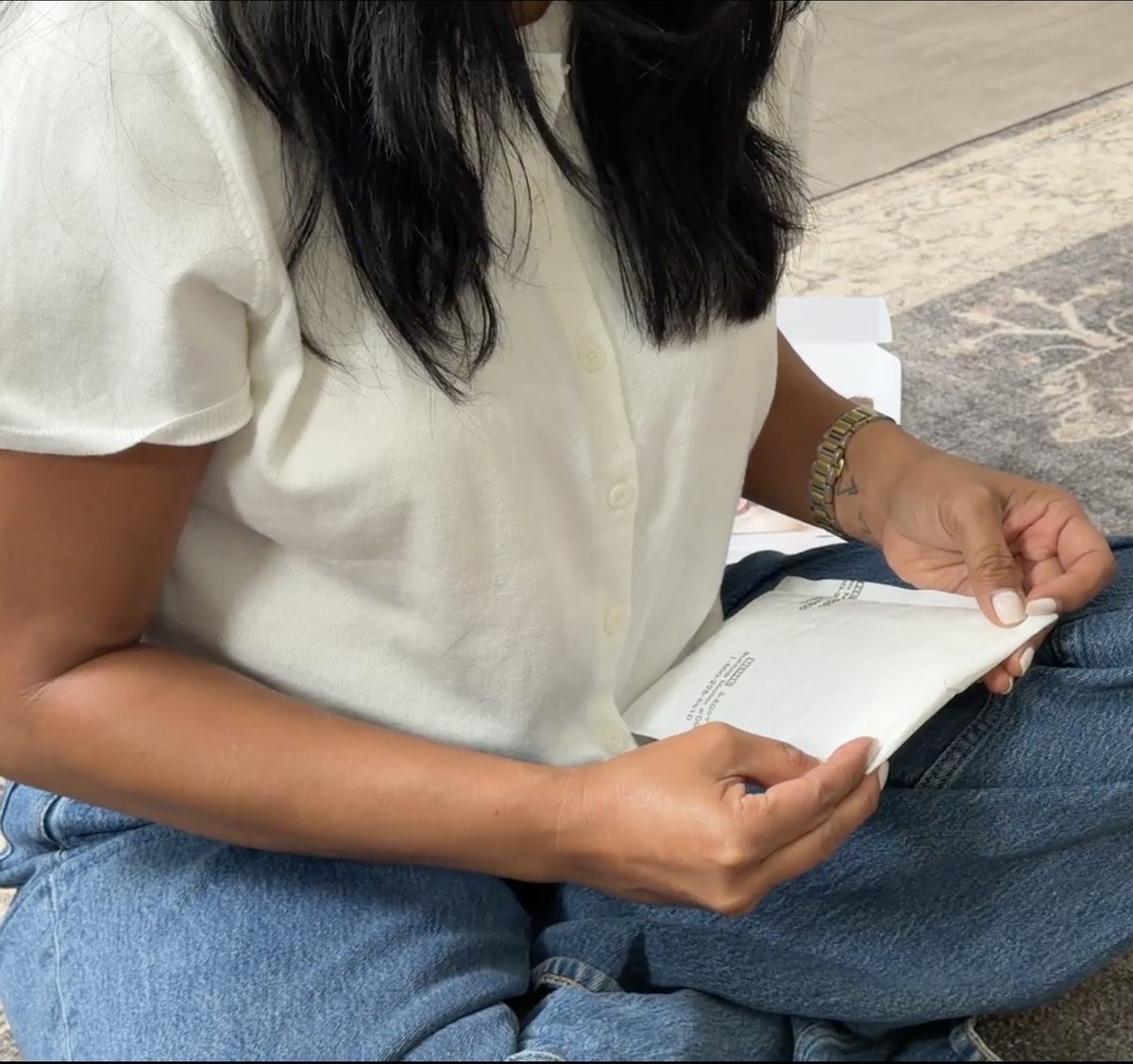 Hands sealing the prepaid return mailer